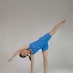 Девушка выполняет асану йоги - Ардха Чандрасана
